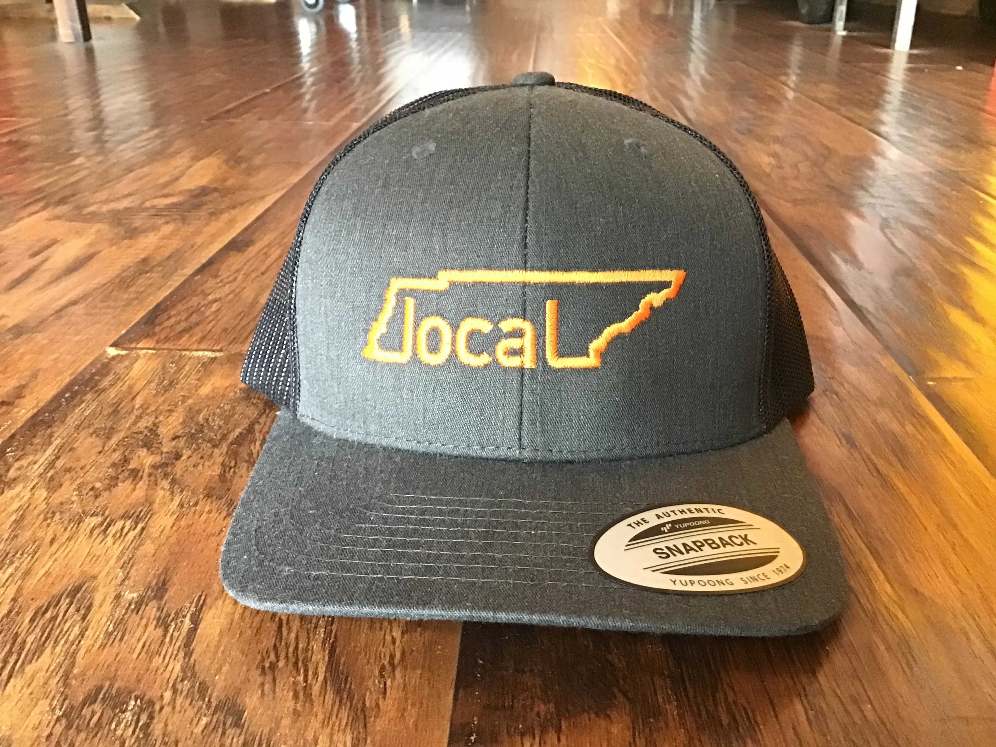 Local Trucker Hat - Dark Heather/Black with Orange Stitching